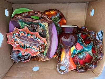 a cardboard box filled with a variety of decorative items