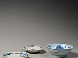 four blue and white bowls with designs on them sitting on a table