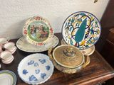 many plates and bowls on a table with a wall in the background