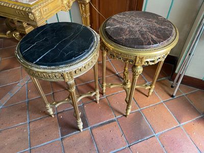 two tables that are sitting on a tiled floor
