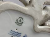 a white vase that has a blue and white design on it
