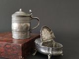 a silver teapot sitting on top of a wooden box