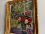 a painting on the wall of a room with a vase of flowers