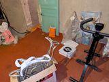 a room that has a bike and other items on the floor