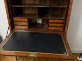 an old wooden desk with a marble top and drawers