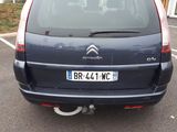 a small blue car parked in a parking lot