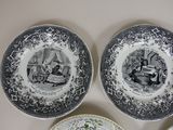 three black and white plates with different designs on them on a table