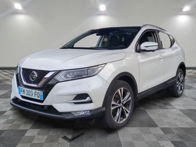 a white nissan suv parked in a garage with a checkered floor