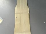 a piece of cardboard on a table next to a pair of scissors