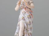 an image of a figurine of a woman holding a flute