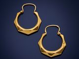 a pair of gold hoop earrings on a blue background