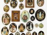 an image of a collection of decorative plates and pictures on a wall