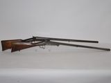 an old rifle with a wooden barrel on a white surface