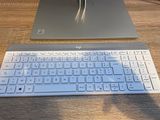 a laptop and a keyboard on a wooden table
