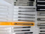 many different types of screws in a plastic container