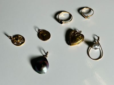 a lot of different rings and pendants on a table