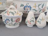 many different types of dishes and bowls on the table