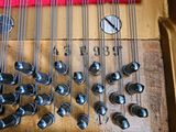 a close up view of a piano with strings and knobs