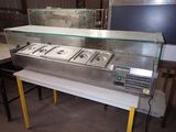 an image of a counter with three hot food pans on it