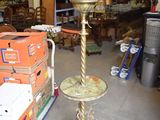 a table with a lamp on top of it in the middle of a room