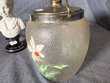 a glass vase with a statue of a boy and a fish in it