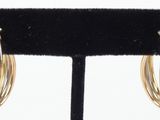 a close up of a pair of earrings on a stand