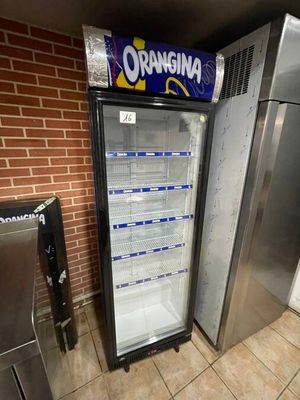 a refrigerator that has a sign on the front of it