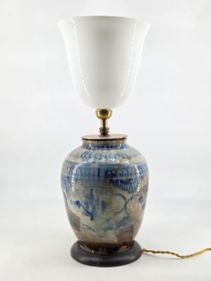 an image of a blue and white vase with a lamp on it