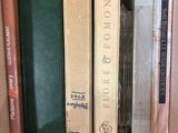 many books that are in a box on the shelf