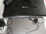 two laptops that are sitting on a table with headphones