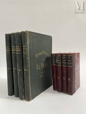 several books are stacked on top of each other on a white surface