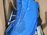 a blue bag that is inside of a blue stroller
