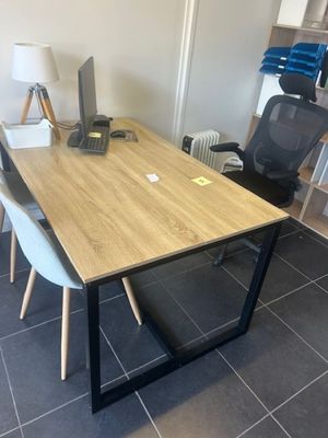 a desk with two chairs and a computer on it