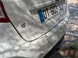 a white car that is parked on the side of the road