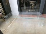 a glass table with a glass top on the floor