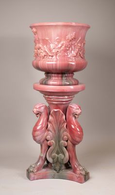 a pink vase sitting on top of a pedestal