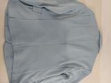 a blue shirt that is laying on a white table
