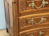 a wooden chest of drawers on a hard wood floor