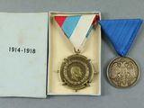 an image of a medal with a ribbon and a medal in a box