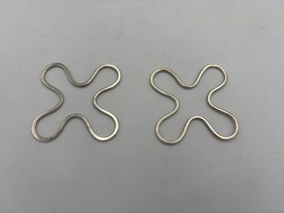 a pair of silver plated earrings with a cross design