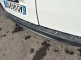 a white car that is parked on the side of the road