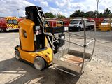 a yellow fork lift truck parked in a parking lot