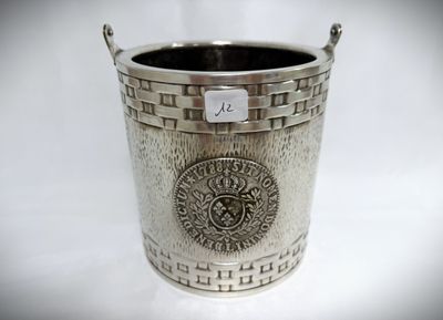 a silver cup with a medallion on it