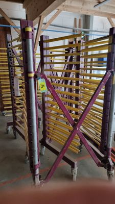 purple and yellow scaffolding in a large warehouse with lots of shelves