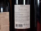 several bottles of wine are lined up on a shelf