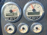 a close up of a car dashboard with various gauges