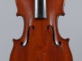 a violin with a bow on a stand on a gray background