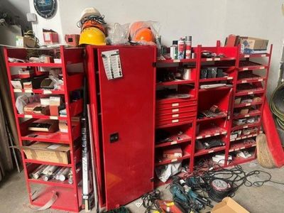 a red cabinet with lots of tools on top of it