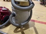 an image of a vacuum and a hose in a warehouse