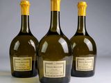 three bottles of wine sitting on top of a table next to each other